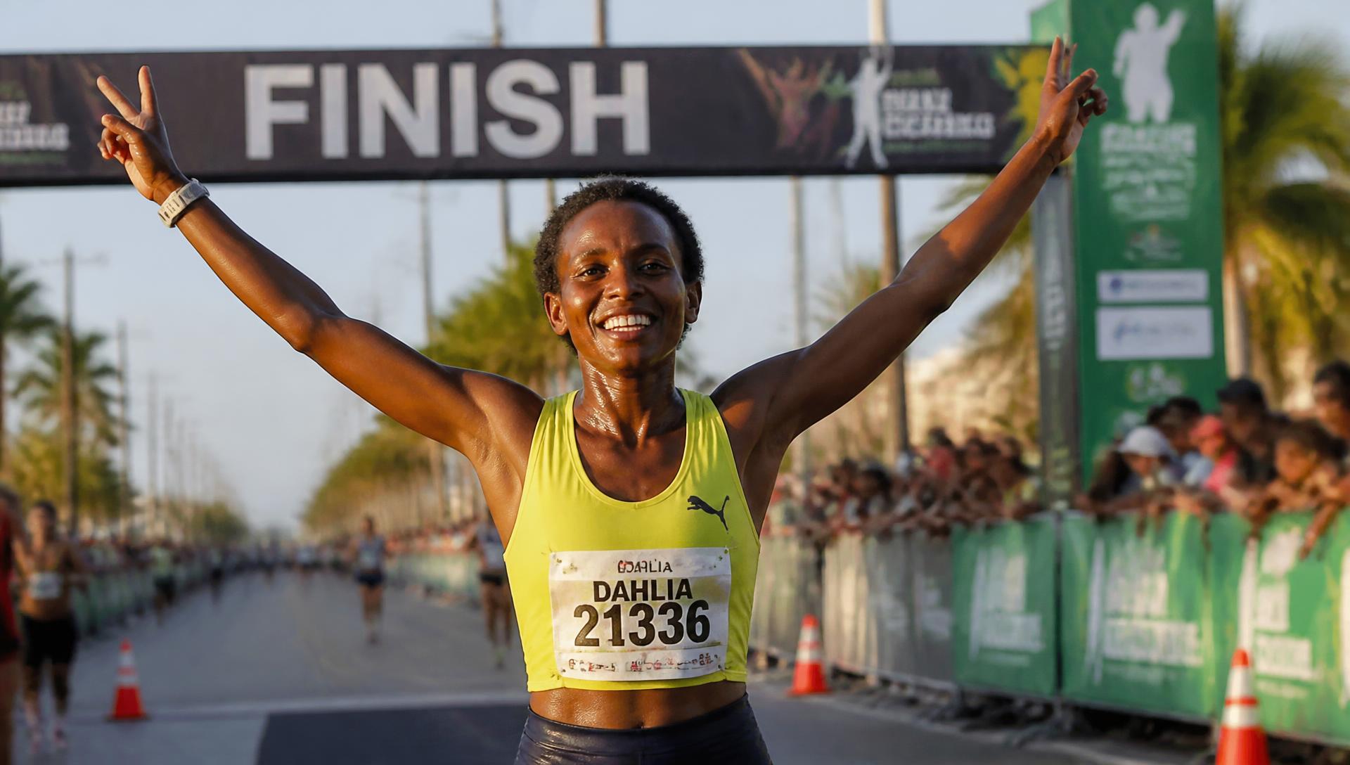 A runner celebrating as she crosses the Run Antigua finish line